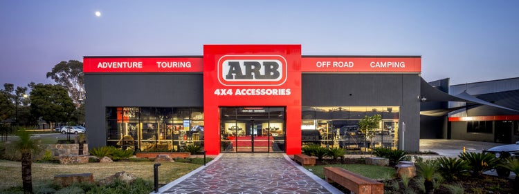 Front view of the ARB Kilsyth store featuring prominent ARB 4x4 Accessories signage, with Adventure, Touring, Off Road and Camping displays visible across the building façade.